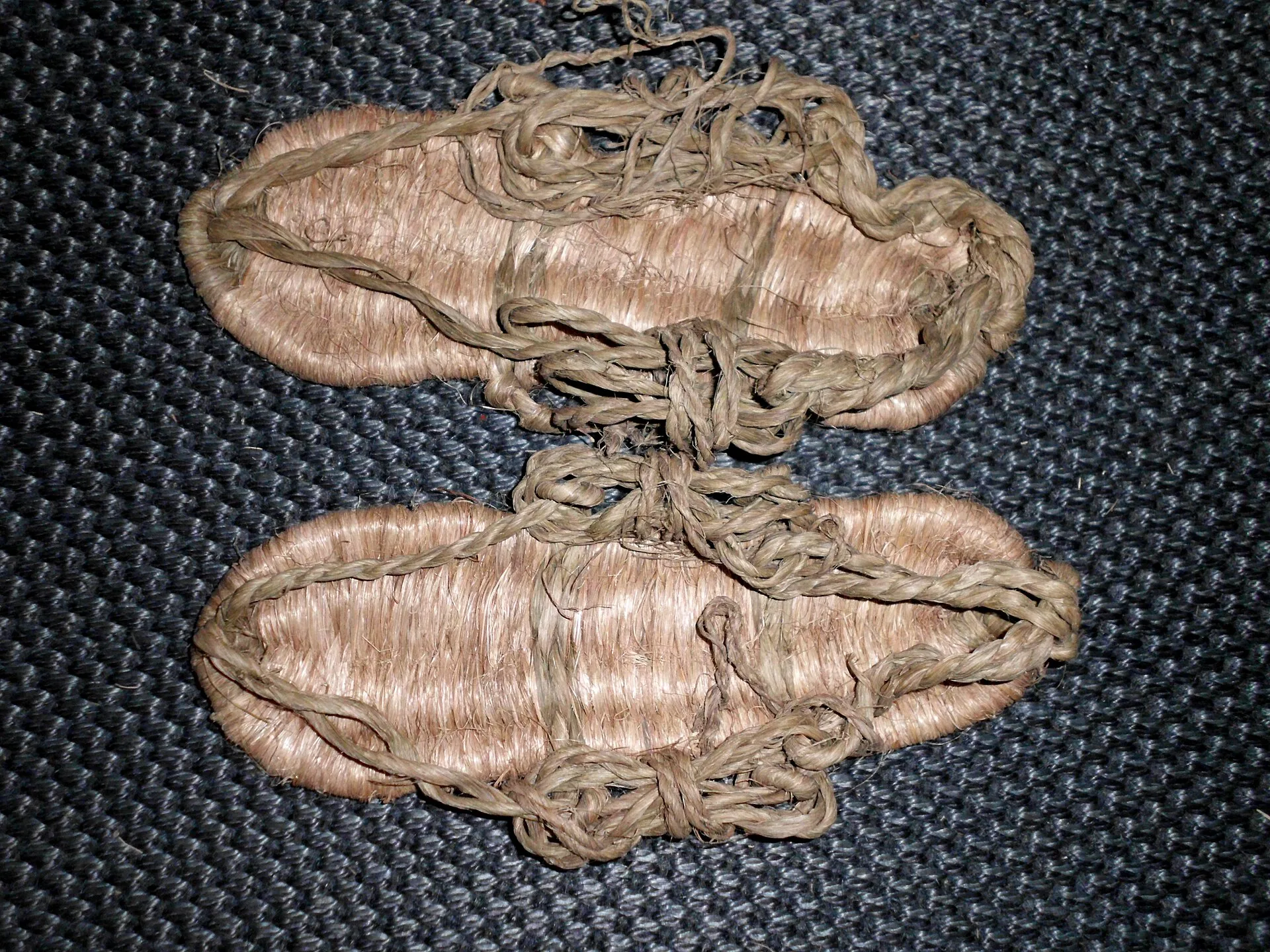 Pair of woven rice straw waraji sandals with straw loops and cords