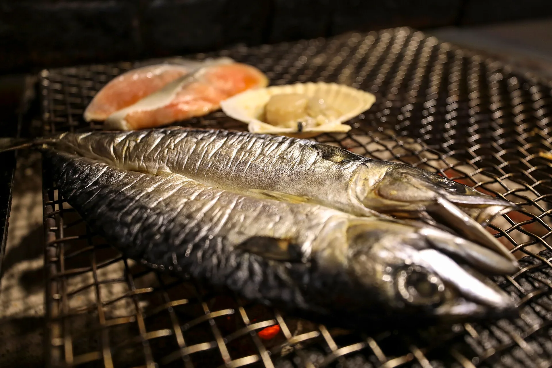 Fish and a scallop on the grill at a robatayaki restaurant in Kushiro