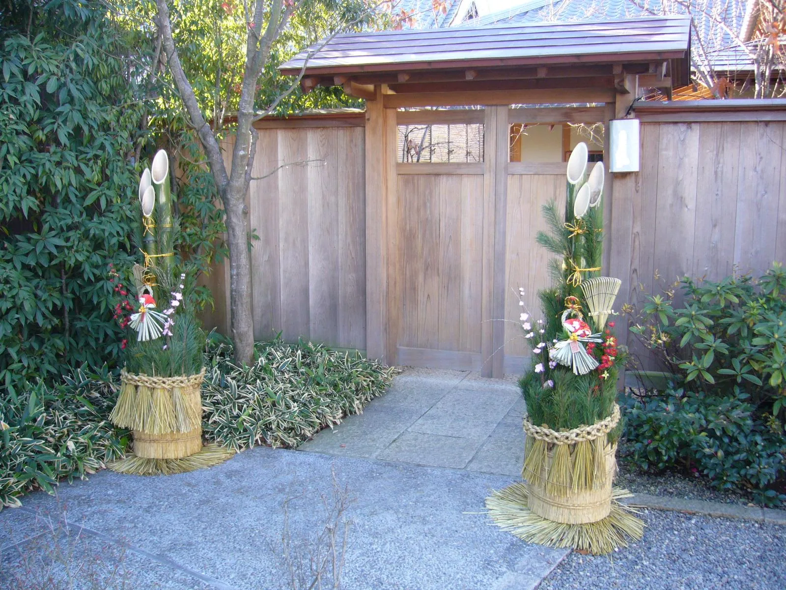 Pair of kadomatsu of pine and cut bamboo at a wooden gate