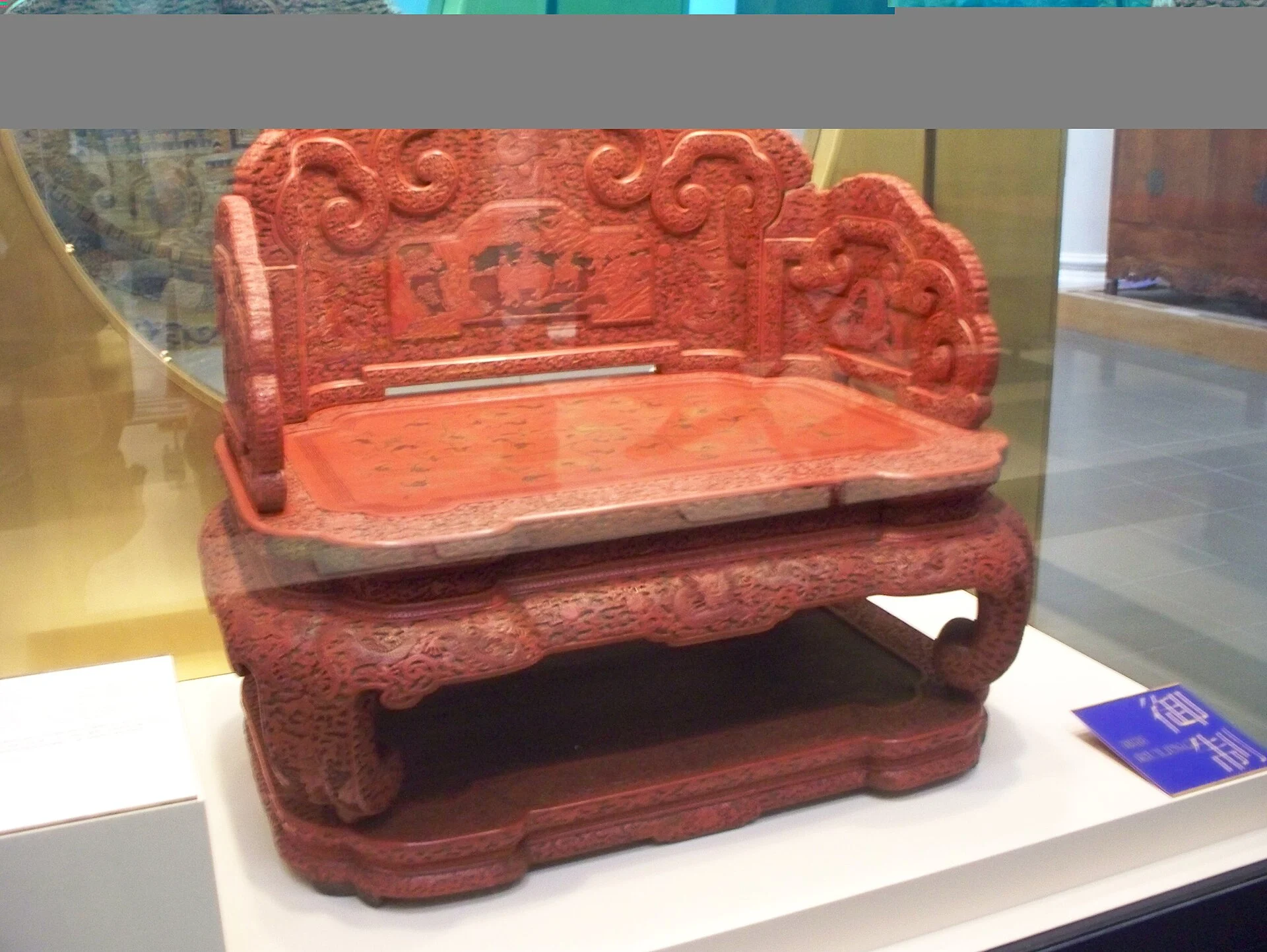 Carved red lacquer imperial throne of the Qianlong period on display