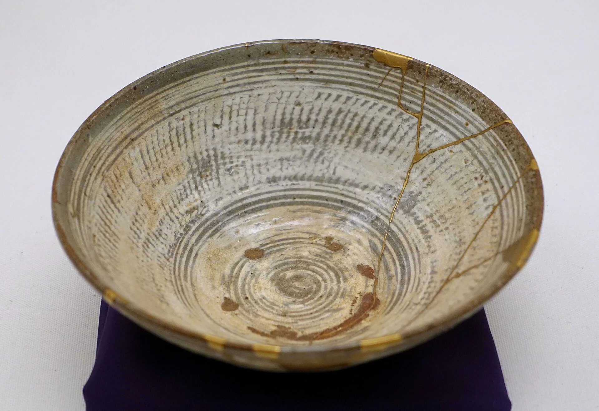 Korean buncheong tea bowl with cracks mended in gold lacquer
