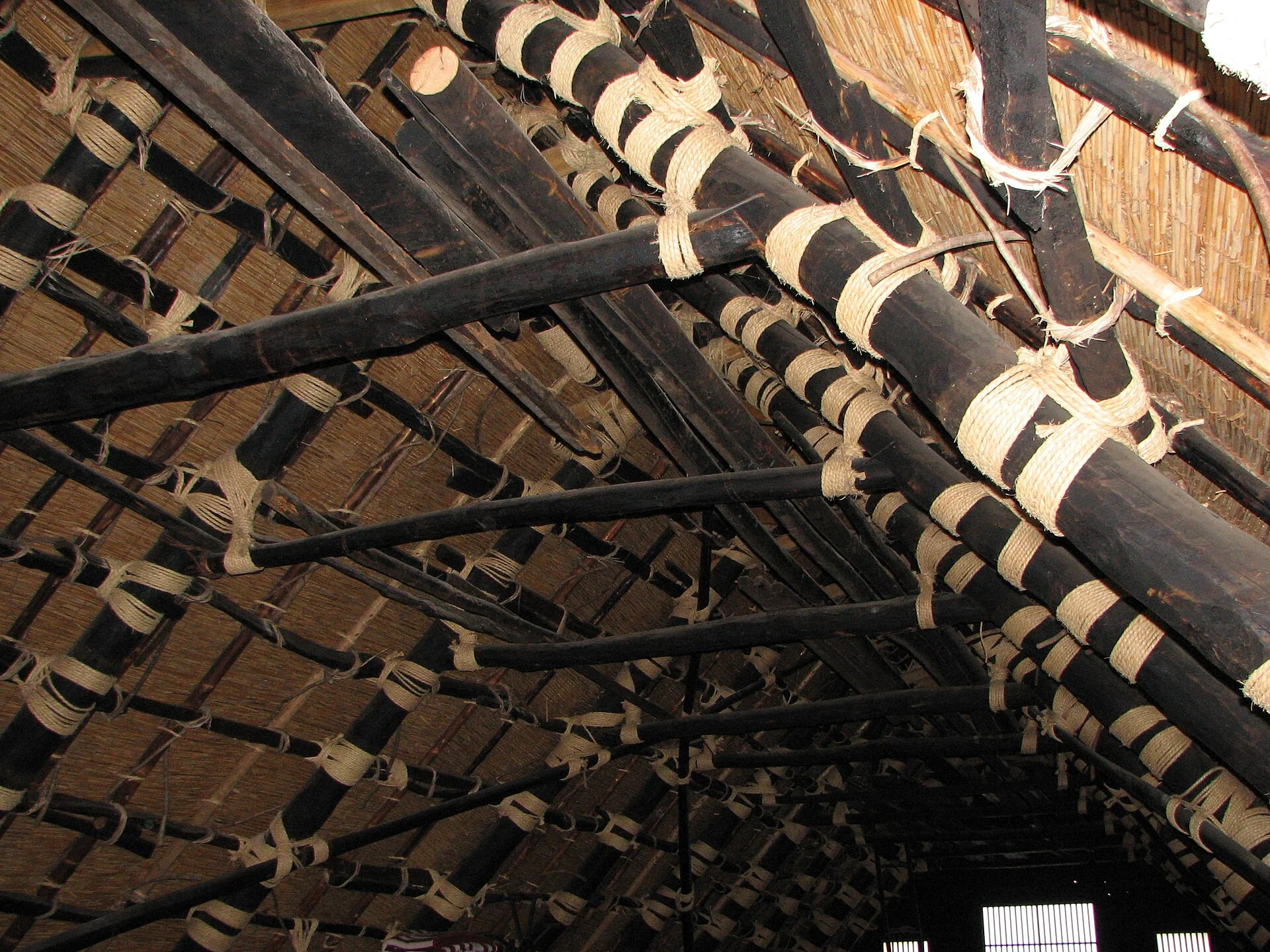 Timber rafters and straw rope lashings inside a gassho-zukuri roof