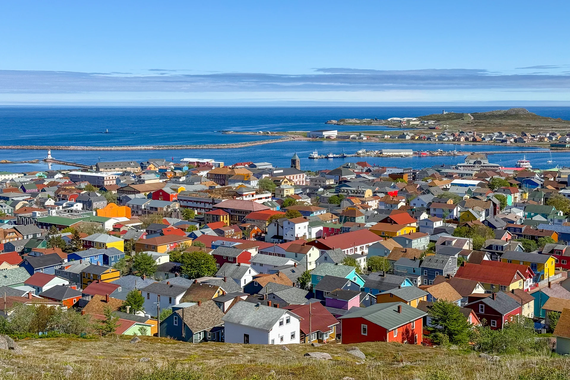 Colourful houses of Saint-Pierre above the harbour and breakwater