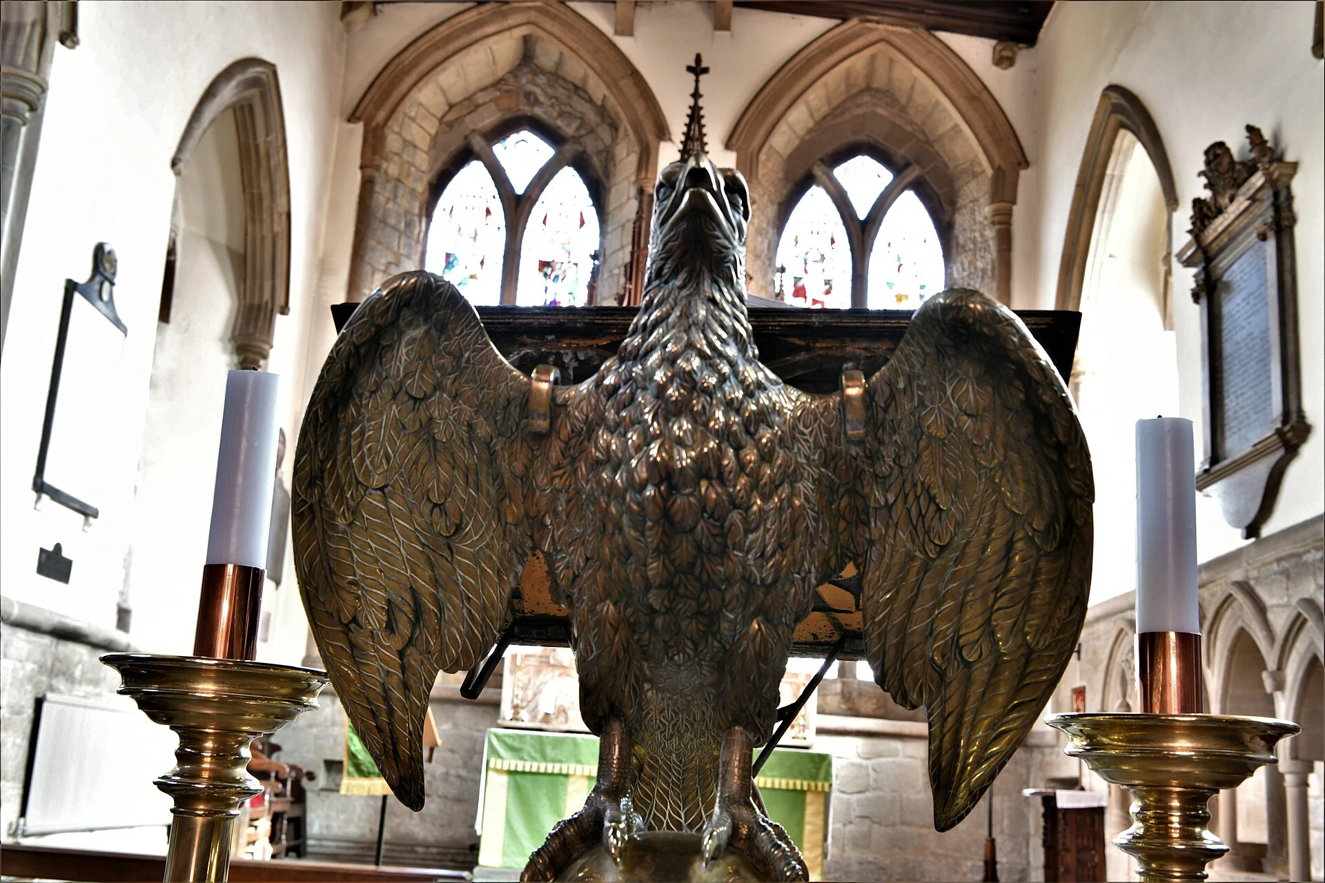 Brass eagle lectern with outspread wings in a church chancel