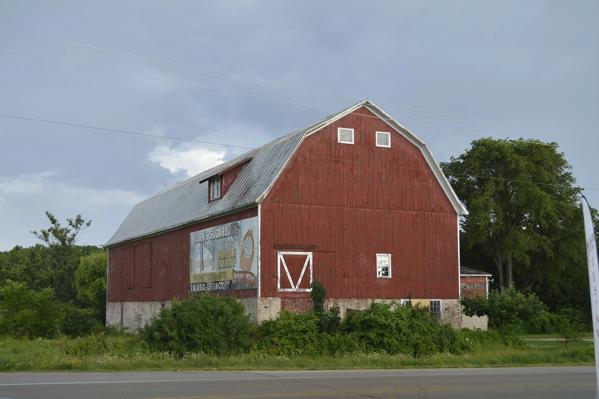 Red gambrel-roofed dairy barn on a farm in Door County, Wisconsin