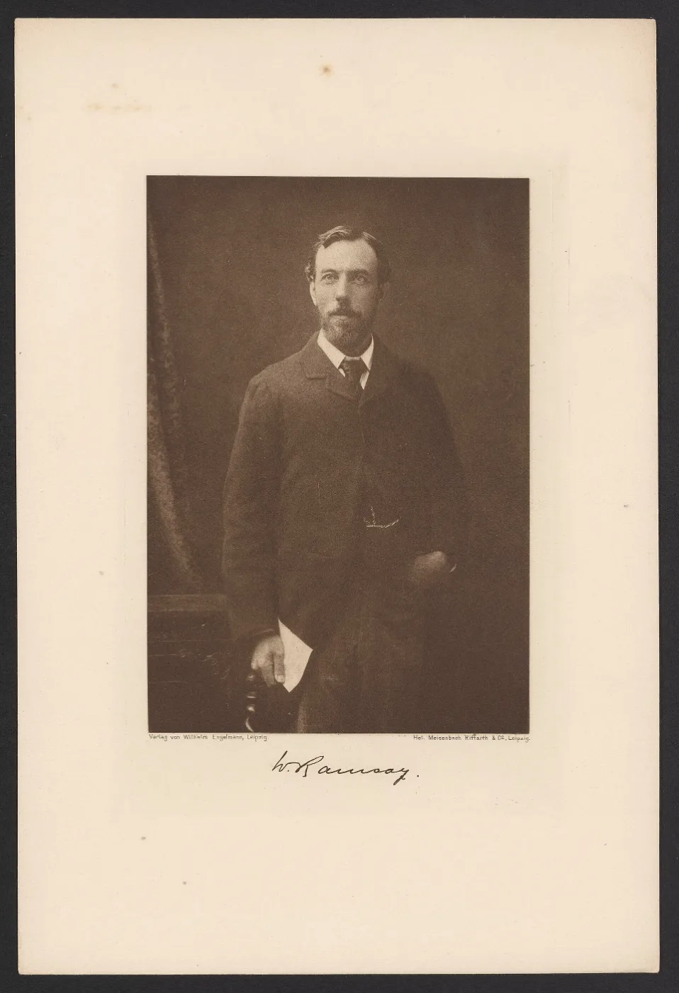 Black and white portrait of a bearded man in a dark suit