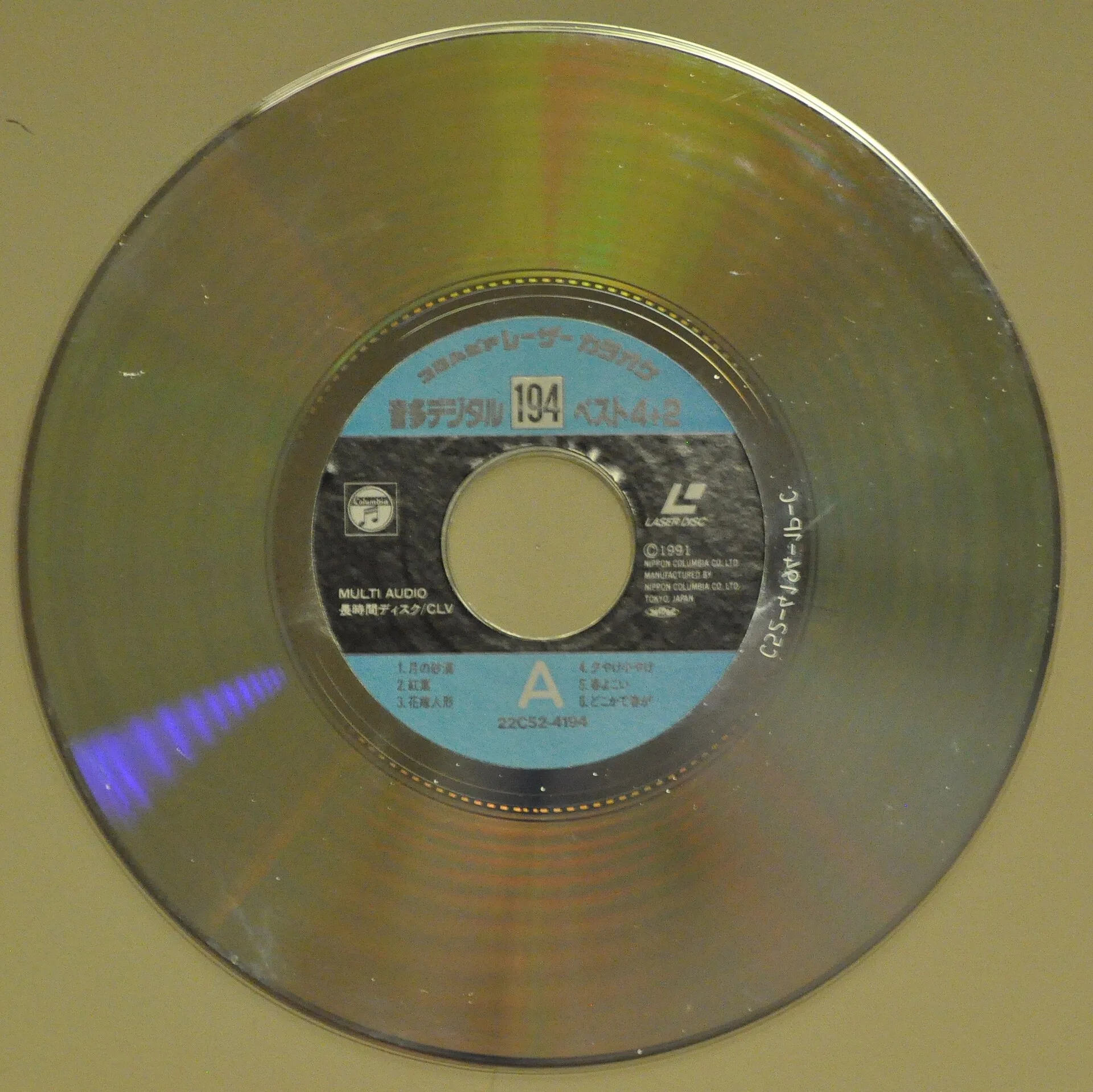 Silver 20 cm laserdisc with a printed karaoke label