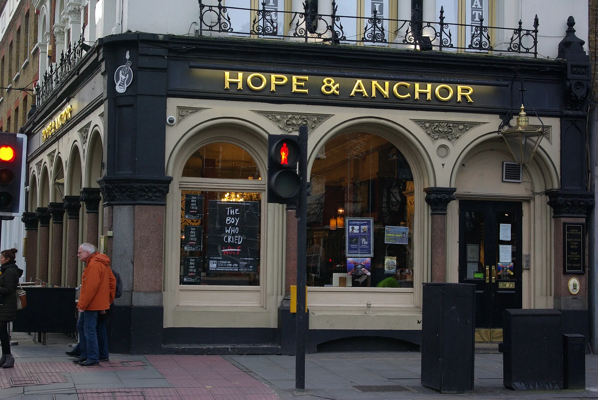 Black pub frontage with gold Hope and Anchor lettering and arched windows
