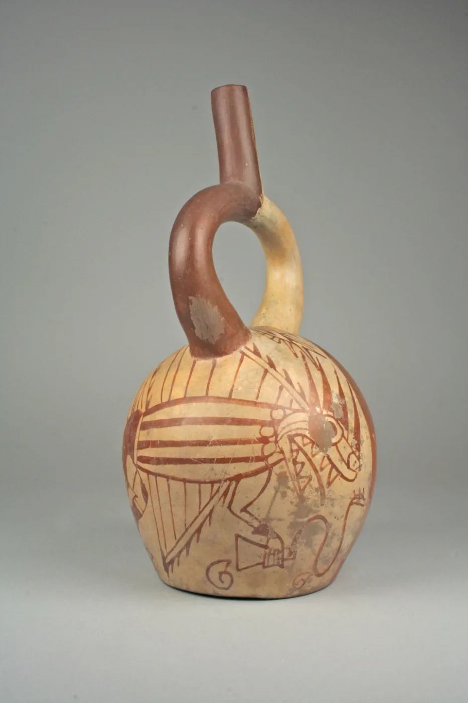 Cream and red painted ceramic bottle with a curved stirrup spout