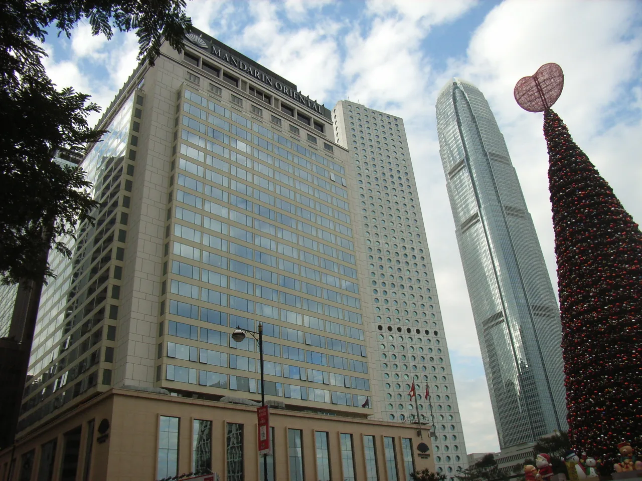 Mandarin Oriental hotel and IFC tower behind Christmas trees in Statue Square