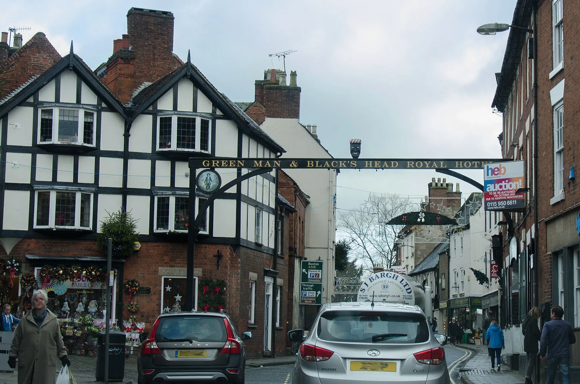 Timber-framed hotel with a gallows sign spanning the street in Ashbourne