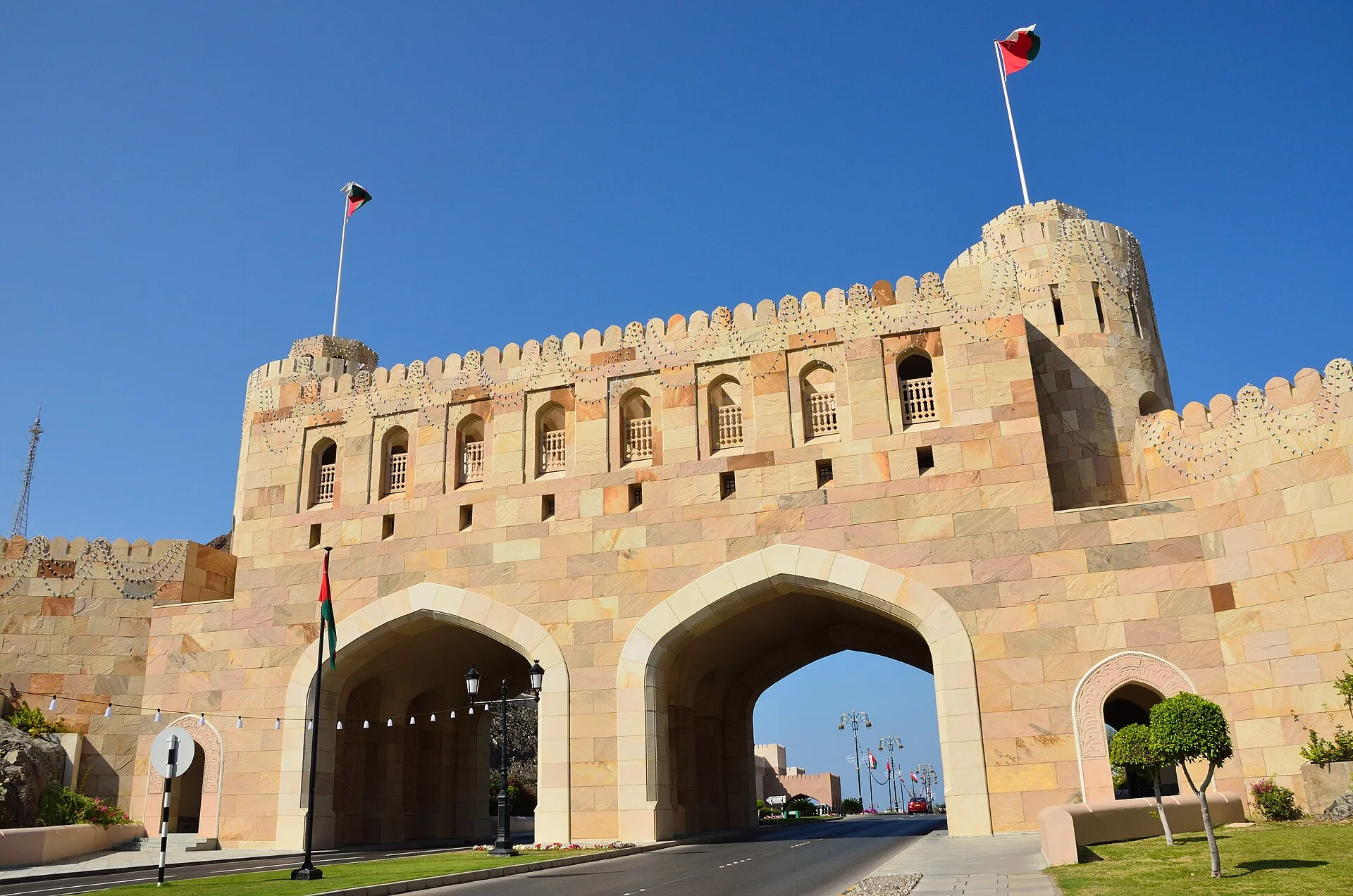 Arched stone gateway with towers spanning a road