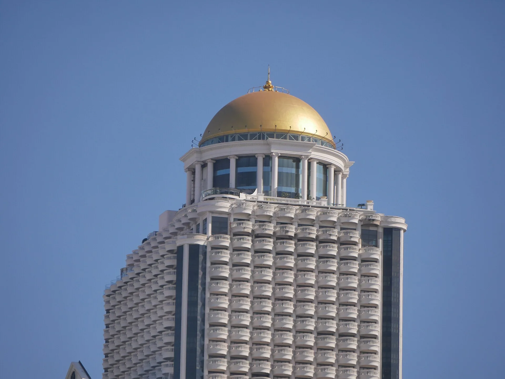 Top of State Tower in Bangkok with its colonnaded drum and golden dome