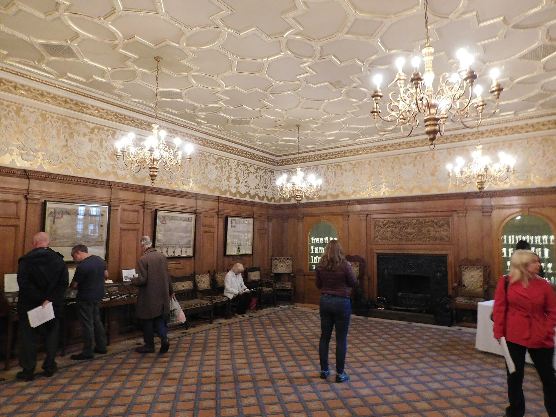 Panelled livery hall with crystal chandeliers, ornate plaster ceiling and chequered floor