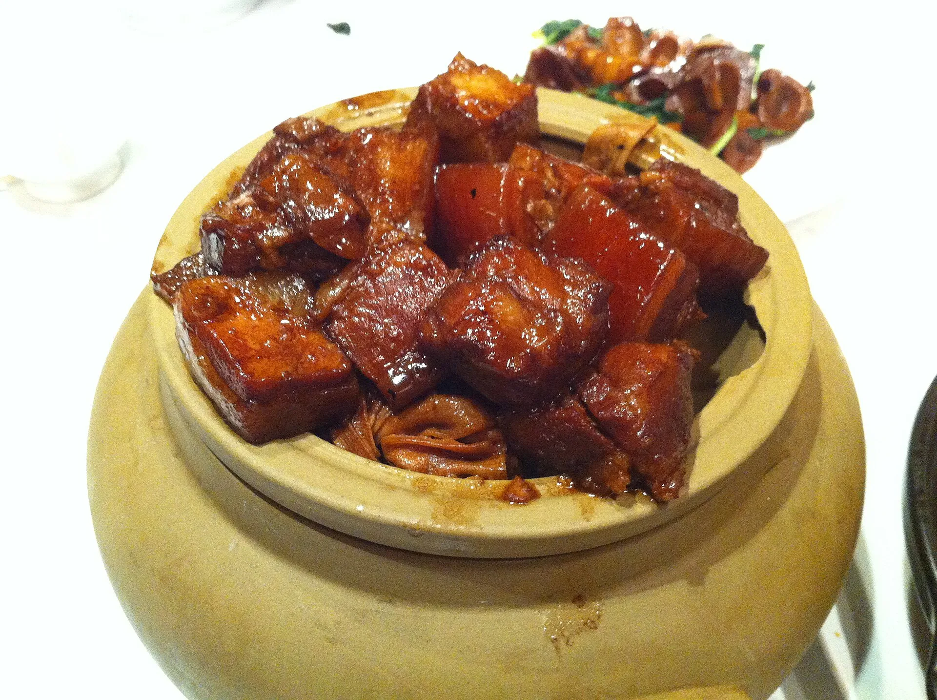 Glossy dark red braised pork belly pieces served in a bowl
