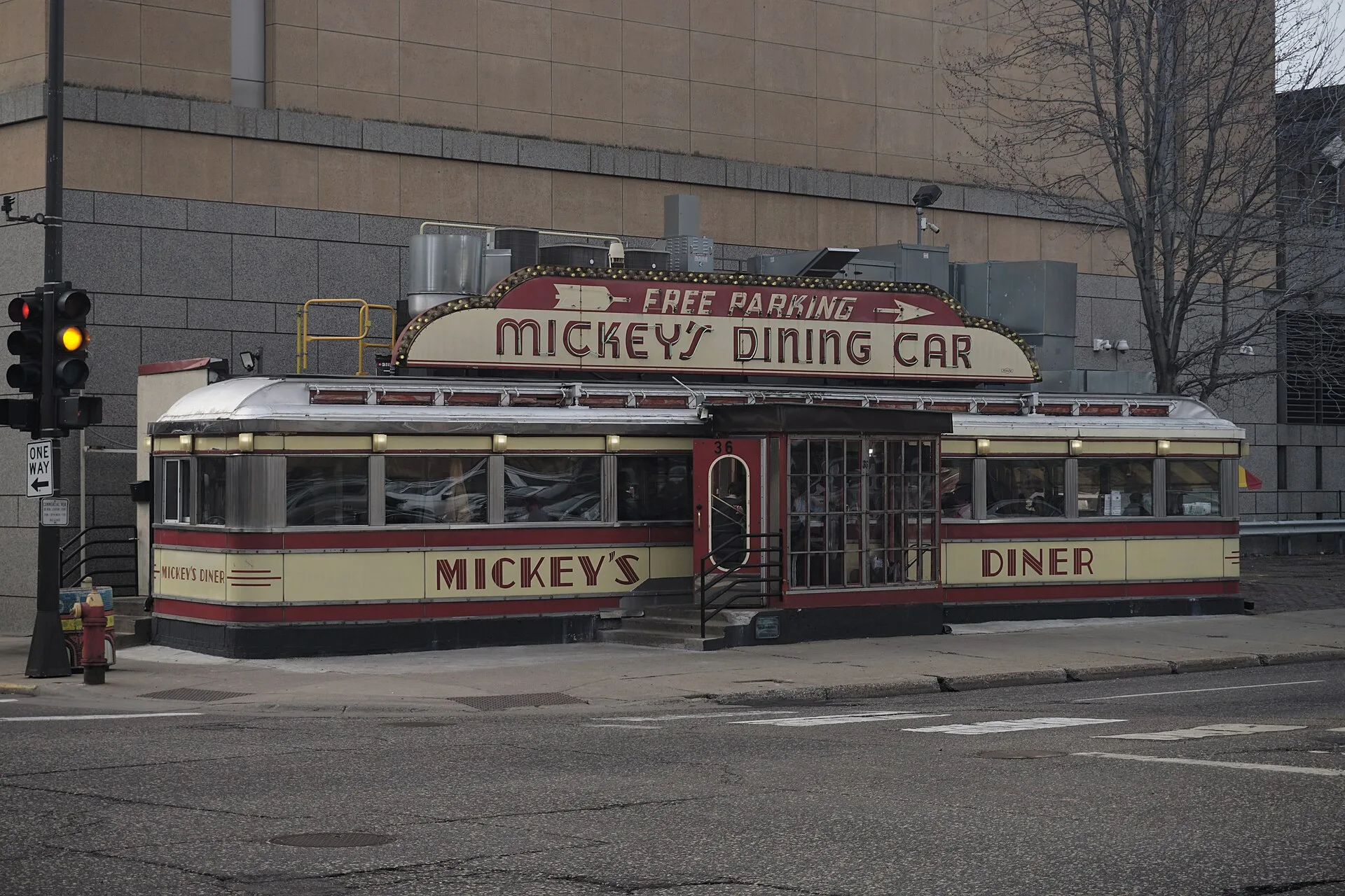 Railroad dining car style diner with red and cream enamel panels on a street corner