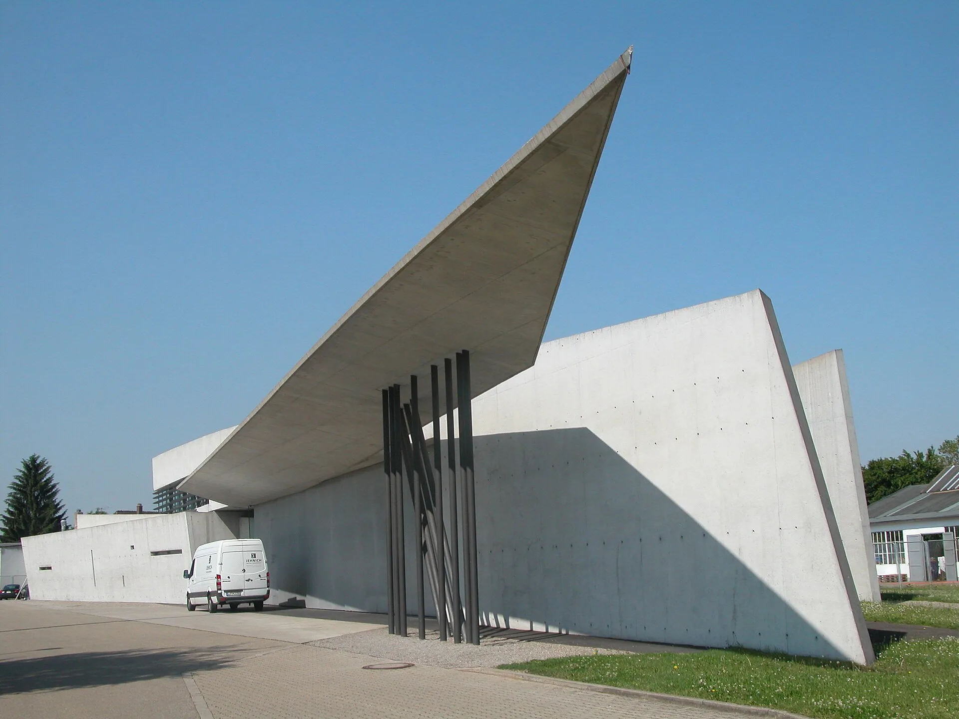 Angular concrete building with a sharply pointed cantilevered roof