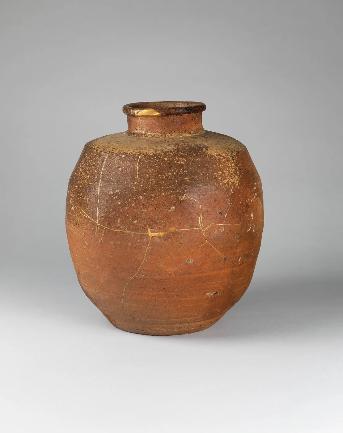 Stoneware jar with natural ash glaze dripping over a coarse orange body