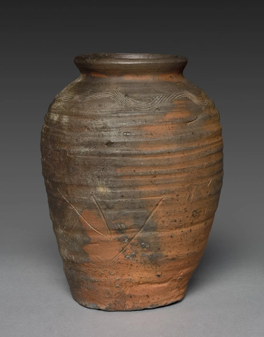 Unglazed brown stoneware storage jar with a rough, kiln-marked surface