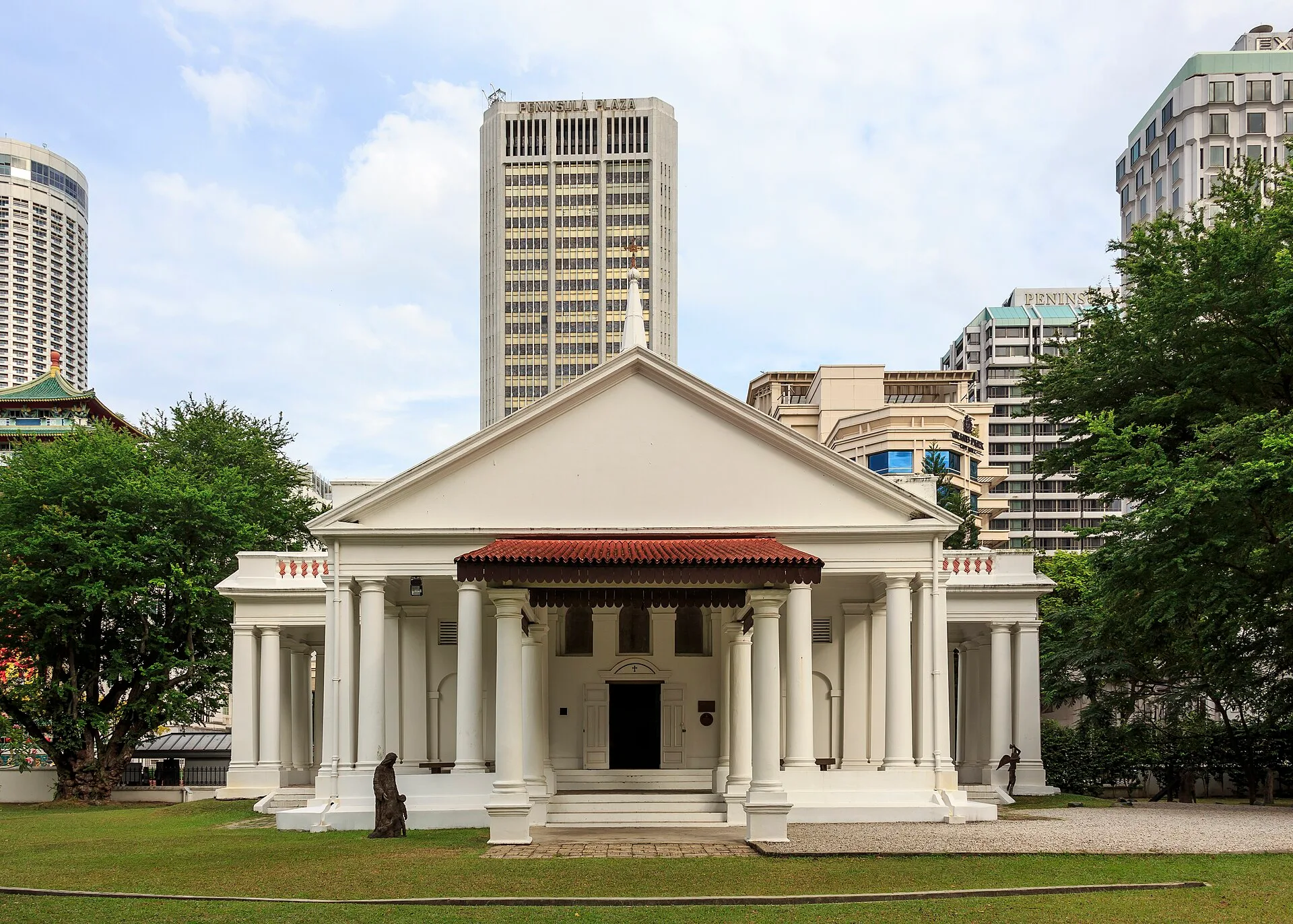 White neoclassical church with a columned portico on a green lawn