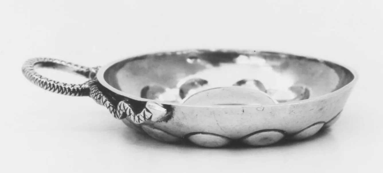 Shallow silver wine tasting cup with a twisted serpent-shaped handle