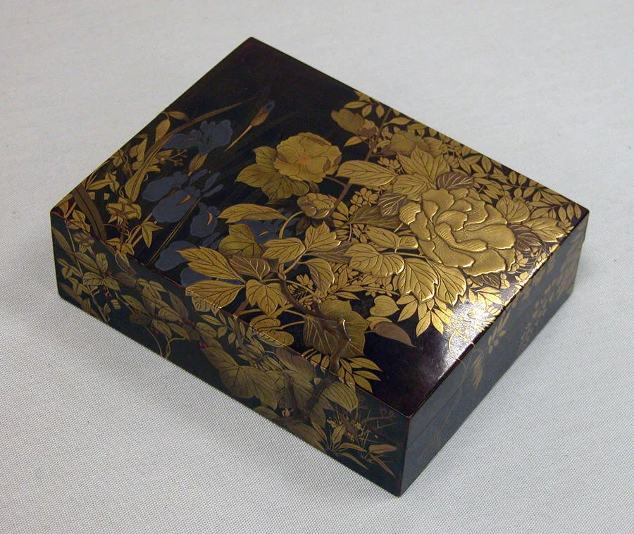 Black lacquer box decorated with gold flowers and leaves