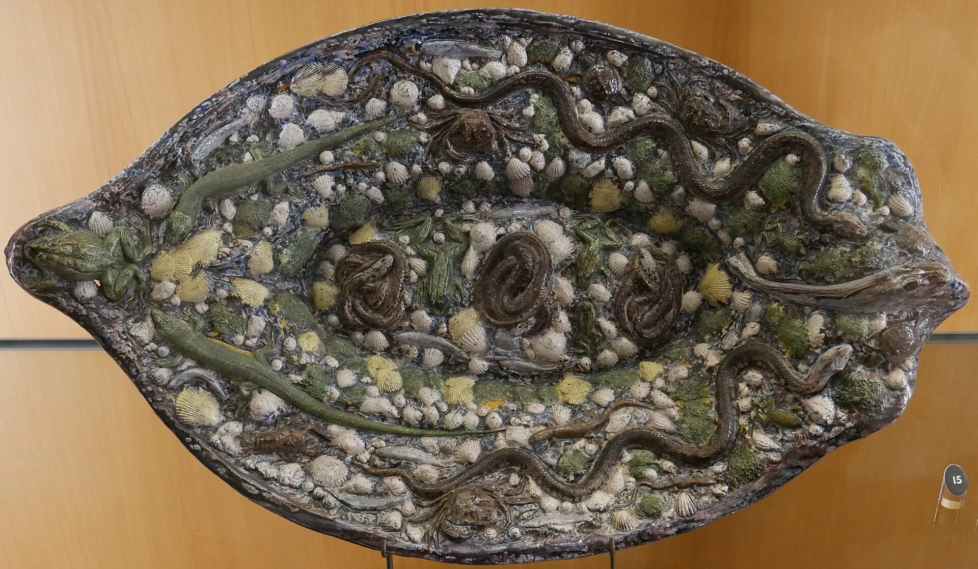 Oval glazed dish covered with modelled snakes, lizards, shells and leaves