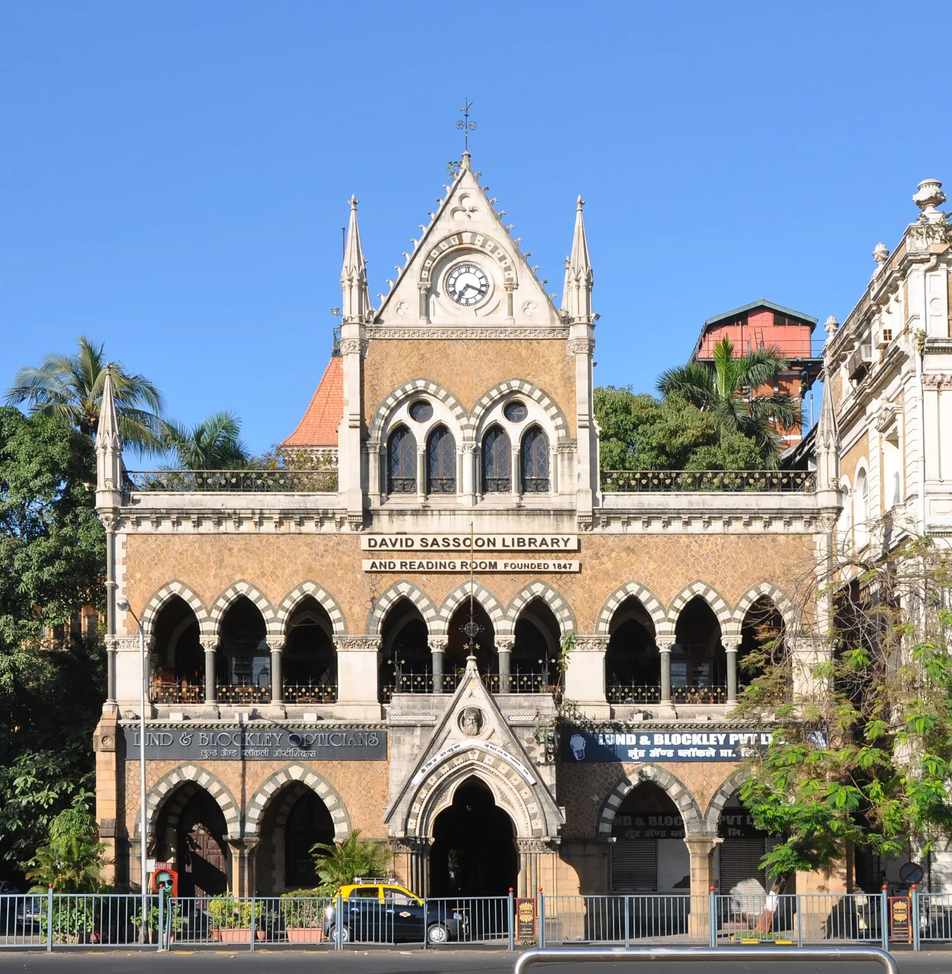 Gothic Revival stone building with pointed arches and a central gabled tower