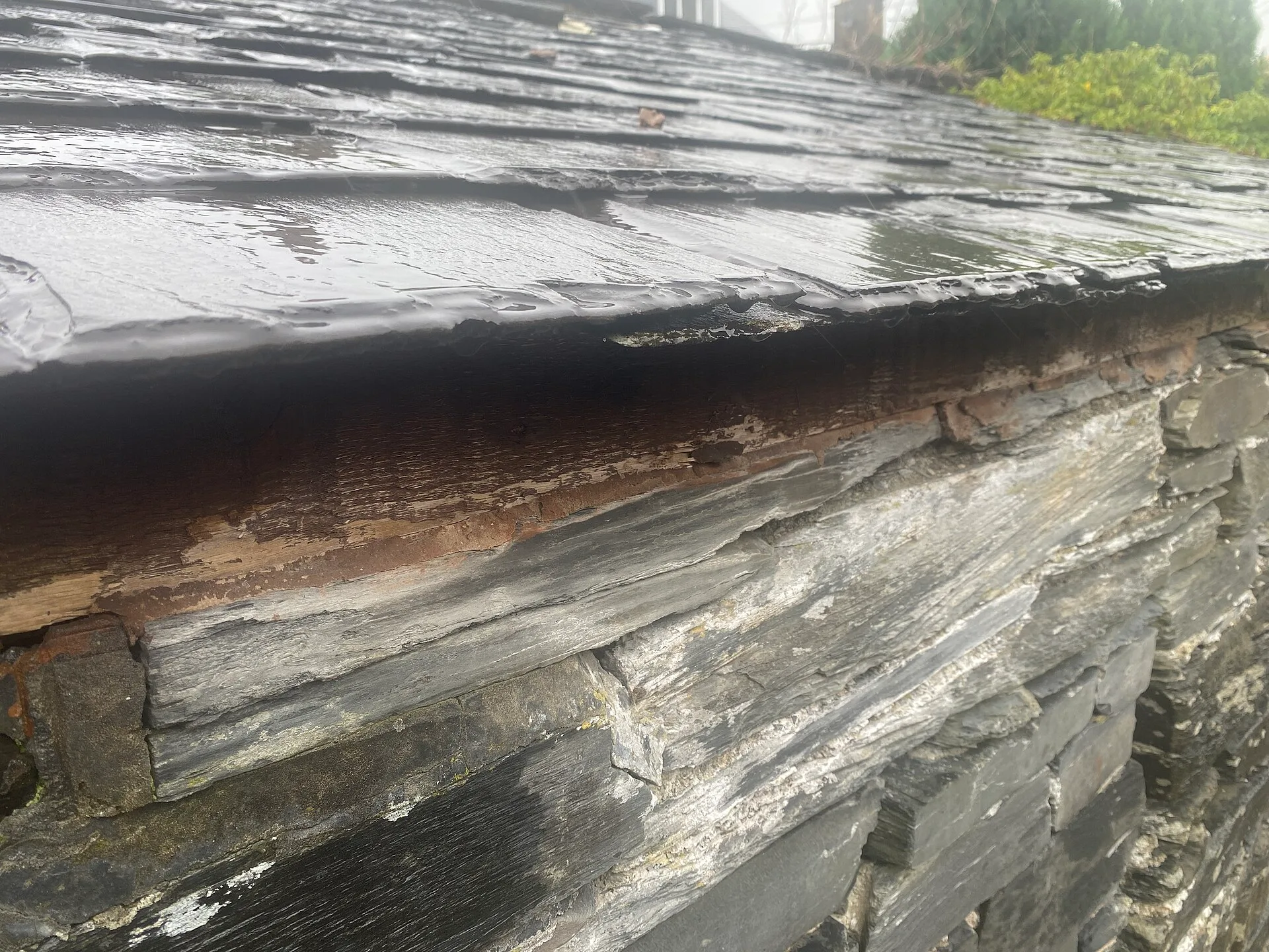 Close view of grey slate with thin layered edges and split surfaces