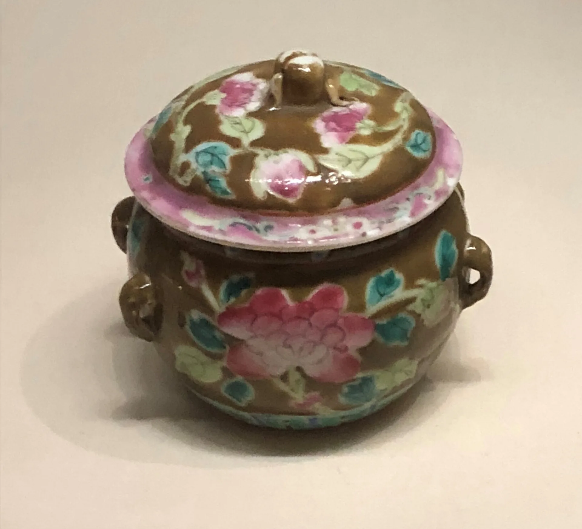 Lidded porcelain jar painted with pink peonies and turquoise leaves