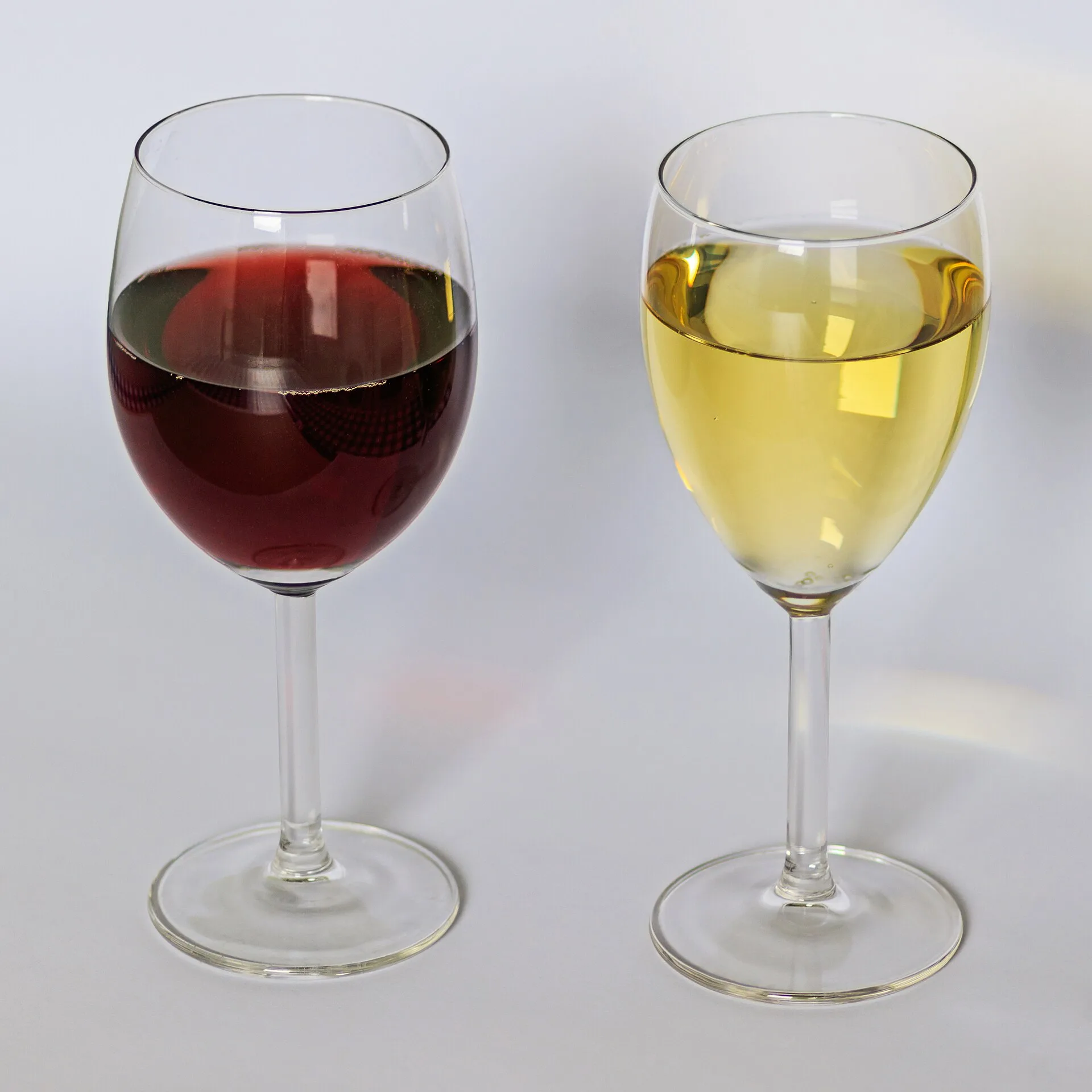 A glass of red wine beside a glass of white wine