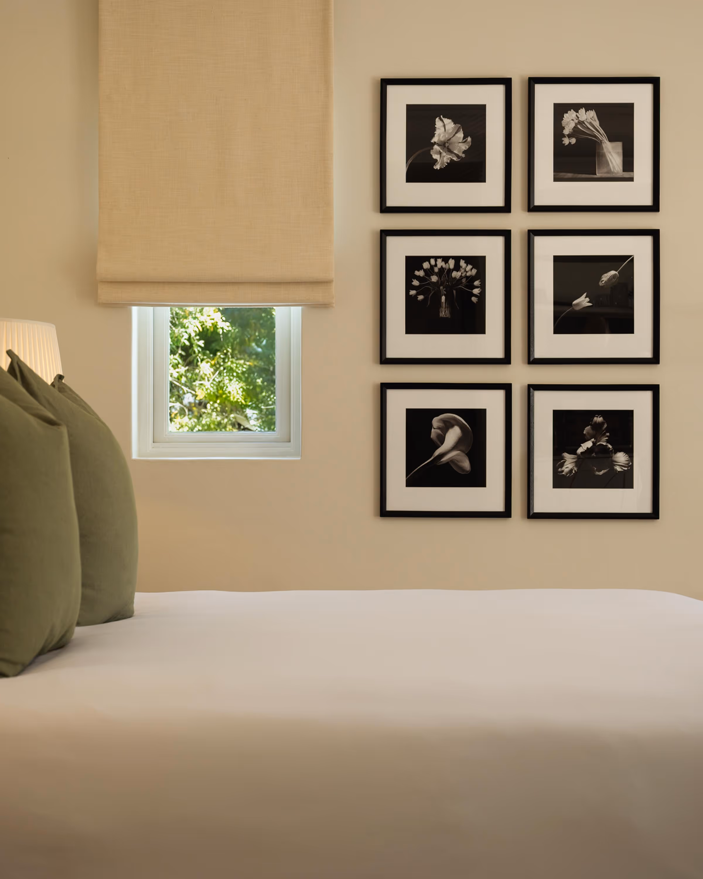Luxury room interior with a photographic display wall. The bed has luxury pillows and duvet