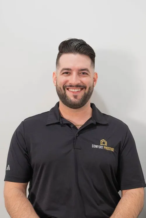 A man wearing a black shirt with a yellow logo.