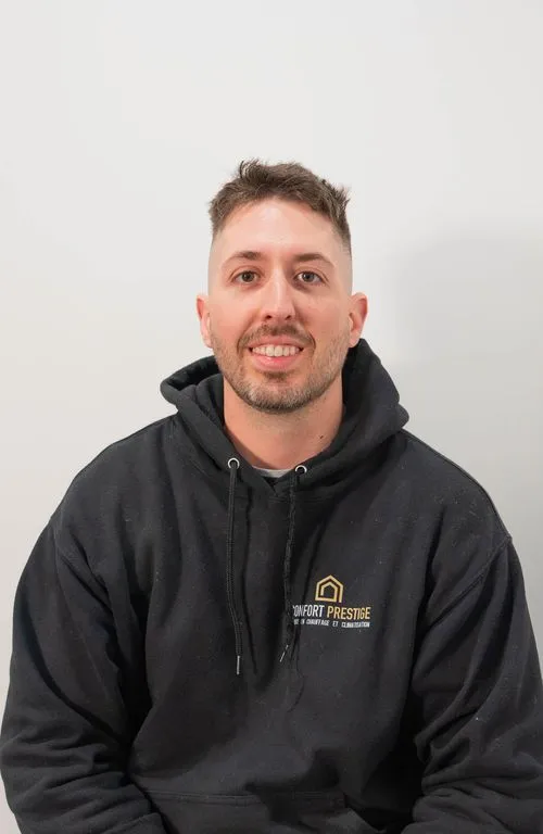 A man wearing a black hoodie with the word "comfort" on it.