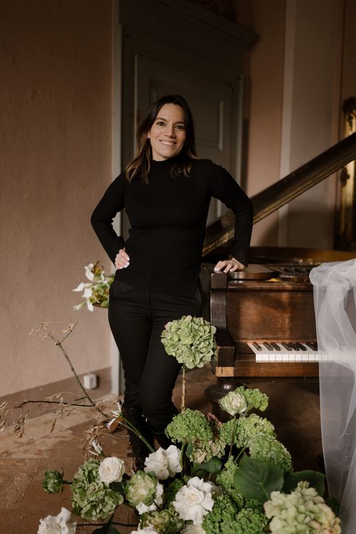 Maria Del Campo, founder and creative director of Ca’ di Campo, captured in an Italian villa among couture details and floral artistry.