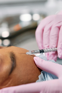 Woman receiving a Botox or Dysport Neuromodulator treatment at Complexion Medspa Cobourg