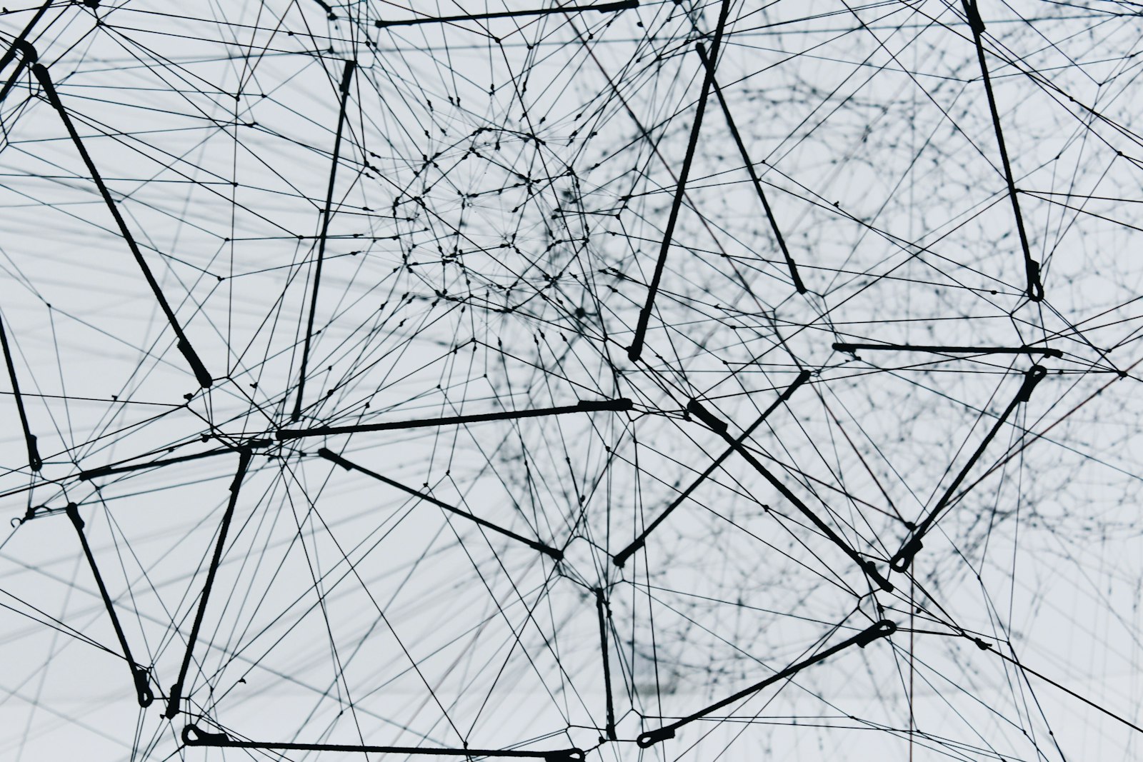 Abstract metal network structure representing connected systems and AI orchestration