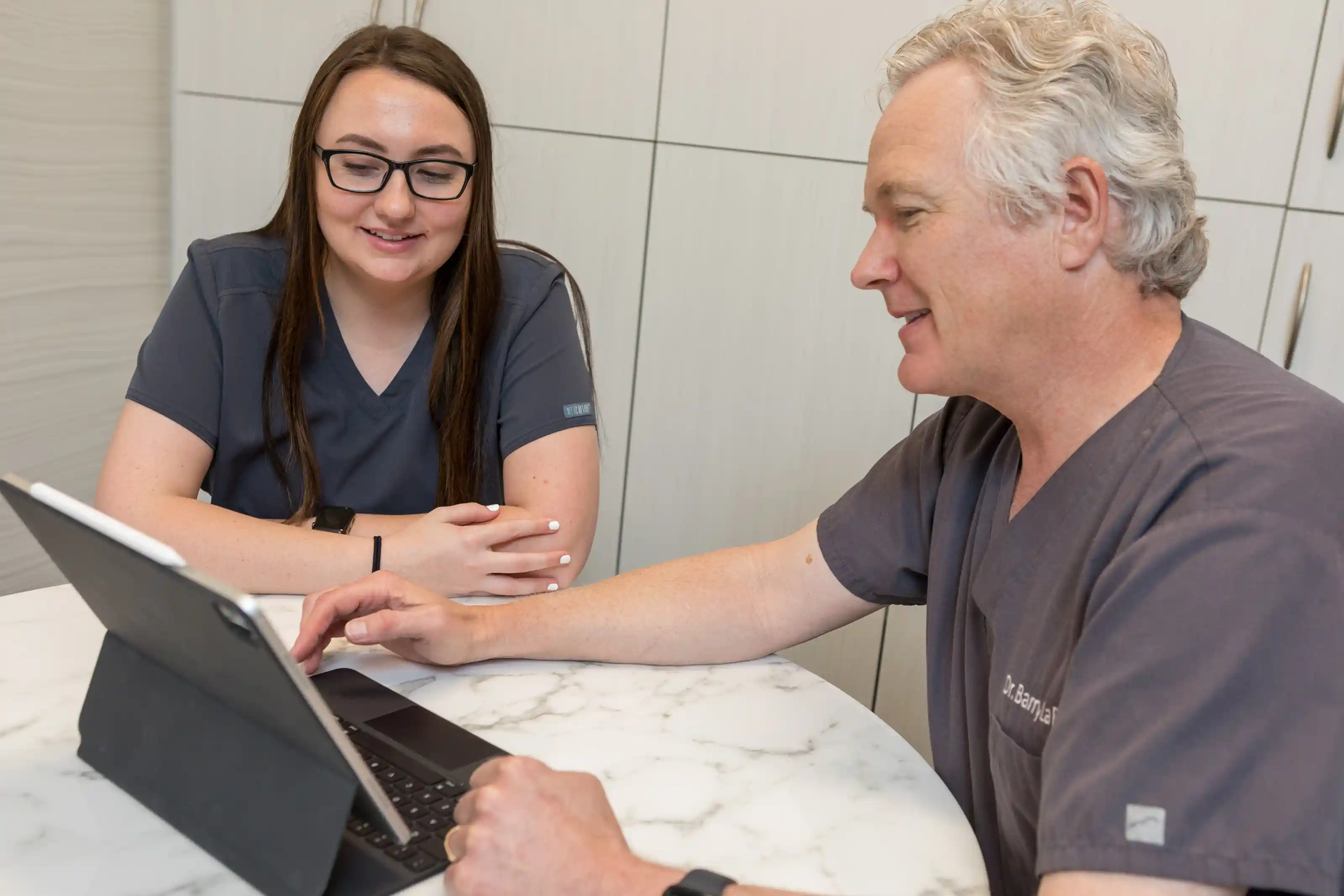Board-certified dermatologist Dr. LaBine consulting with a patient, highlighting compassionate communication and personalized skin health guidance in a clinical setting.