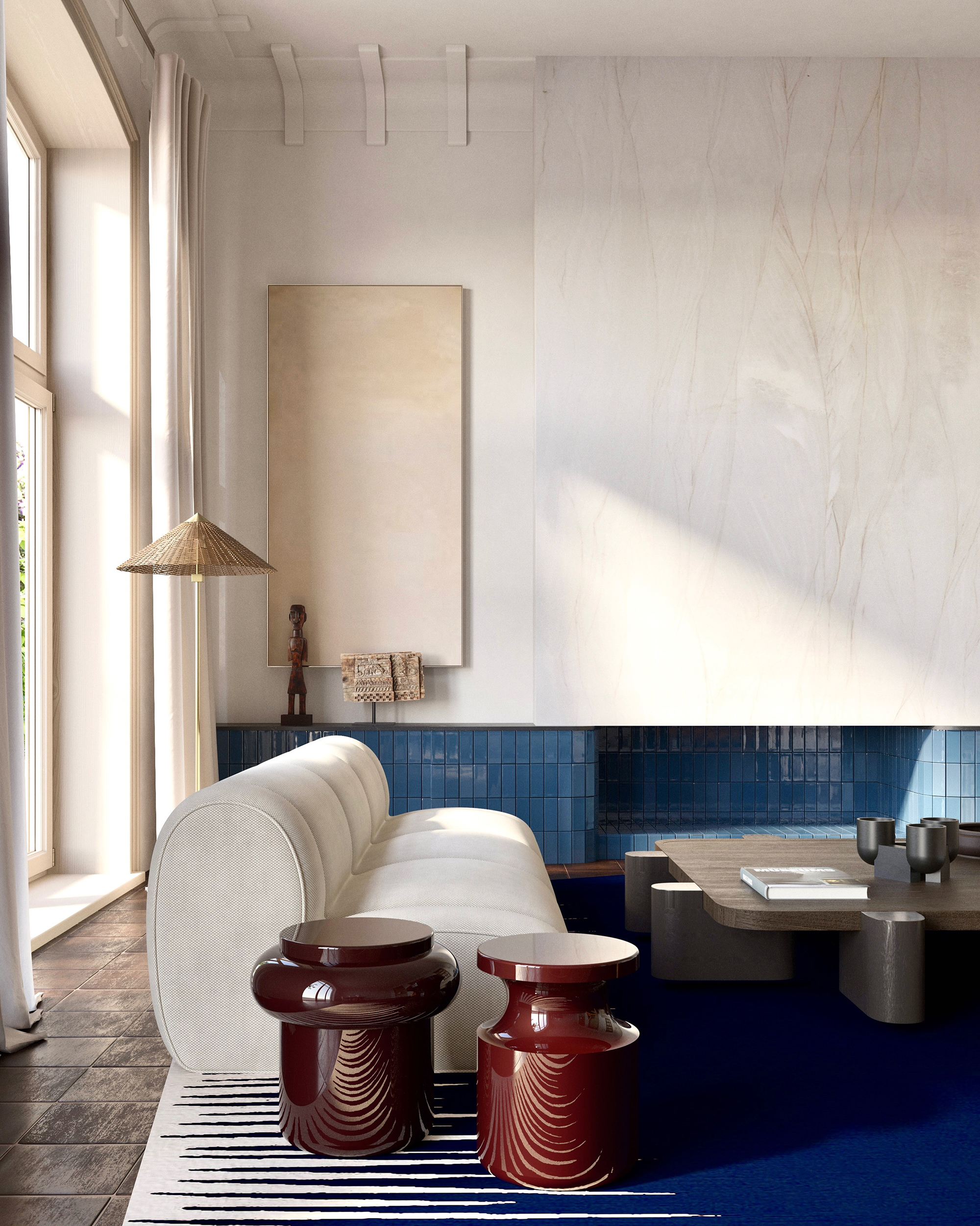 Contemporary living room featuring a rounded white sofa by Popus editions, Invisible Collection against a blue tile fireplace. Two glossy burgundy sculptural side tables by Delcourt Collection add contrast atop a graphic blue-and-white rug by Atelier Fevrier. Neutral artwork and minimal vintage accessories? sculpture by Joan Miro and leather De Sede vintage lounge chair complete the scene. {vertical}