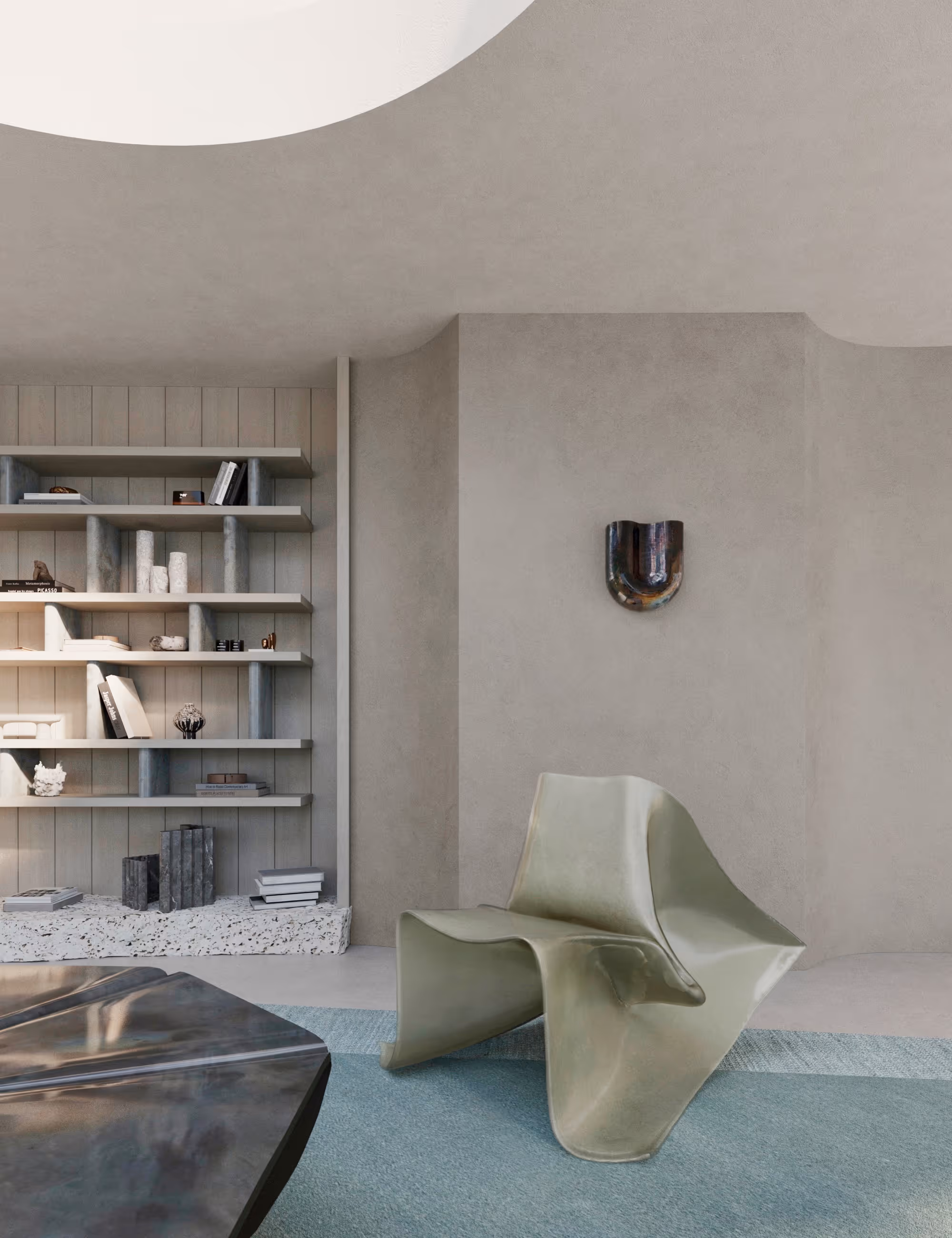 Detail view of the living area showing Fold Chair in raw fiberglass, Onda ceramic sconce, and shelving built into sculpted walls. {vertical}