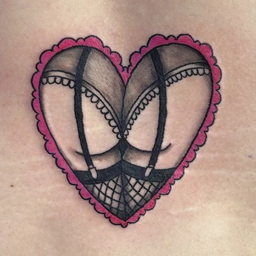 Tattoo of buttocks with fancy lingerie inside a heart shape by Kenny White Noise Tattoo