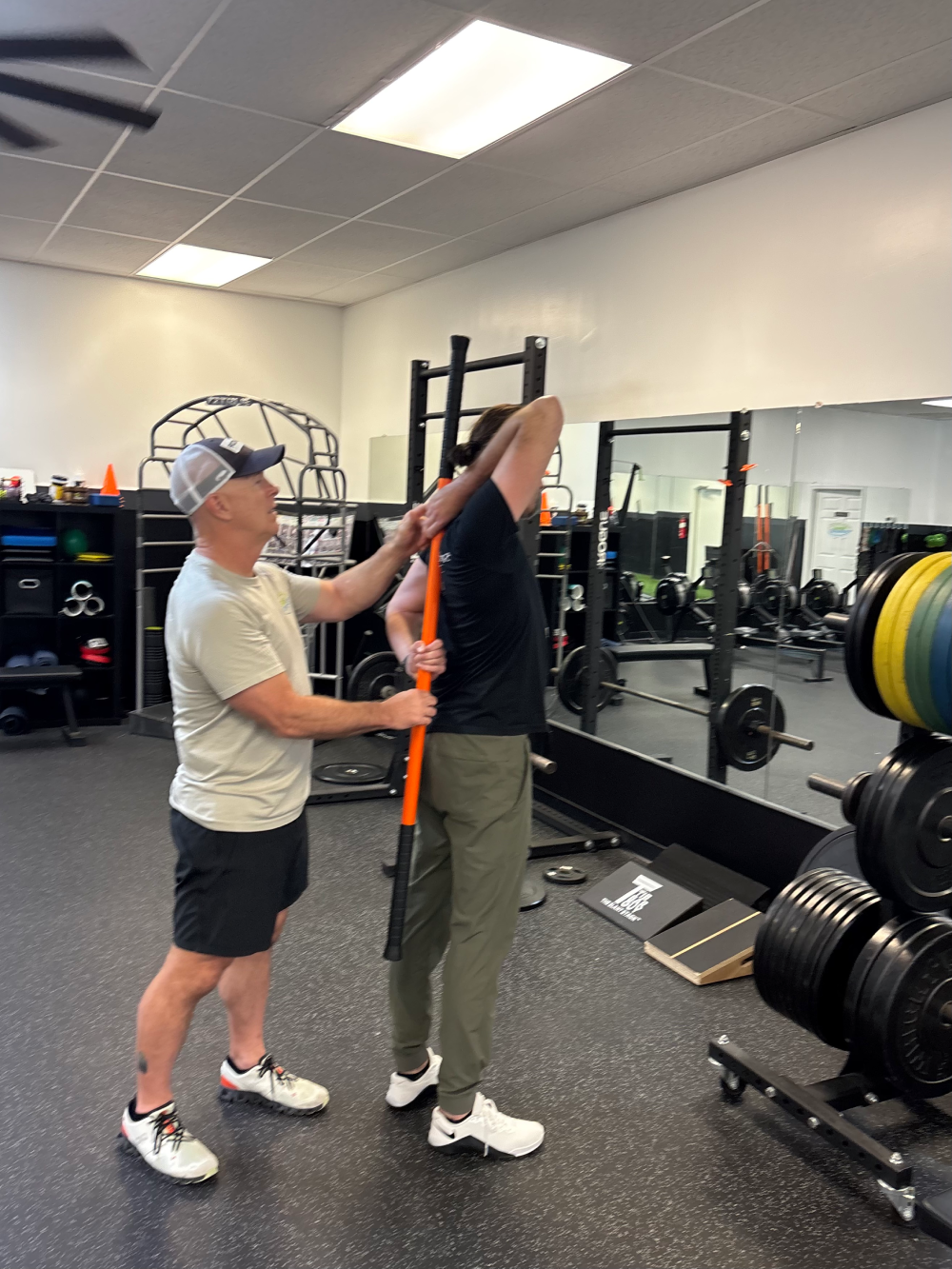 A group of individuals practicing yoga in a gym at Sarge Athletics, Ocean View, DE, showcasing various poses and focus.