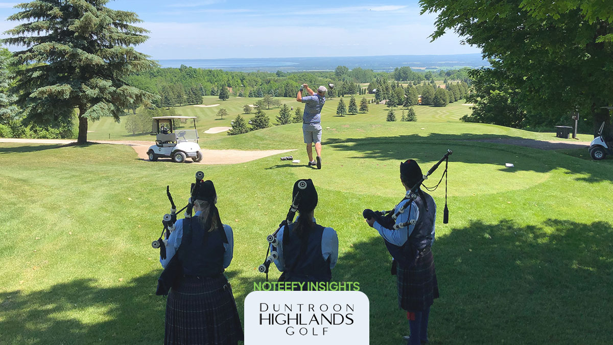 Golfer teeing off at Duntroon Highlands as three bagpipers look on