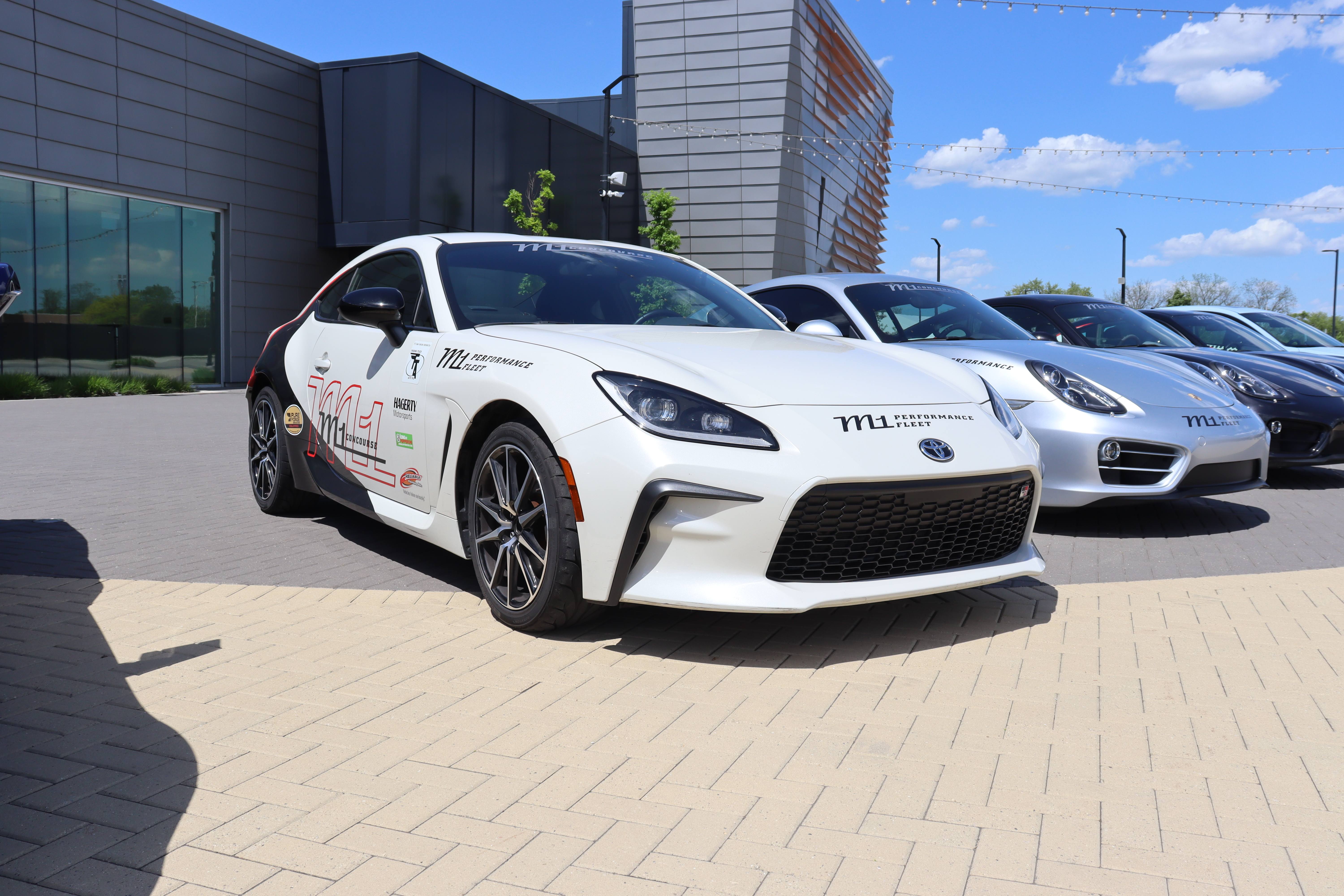 Parked white car on M1 Concourse plaza.