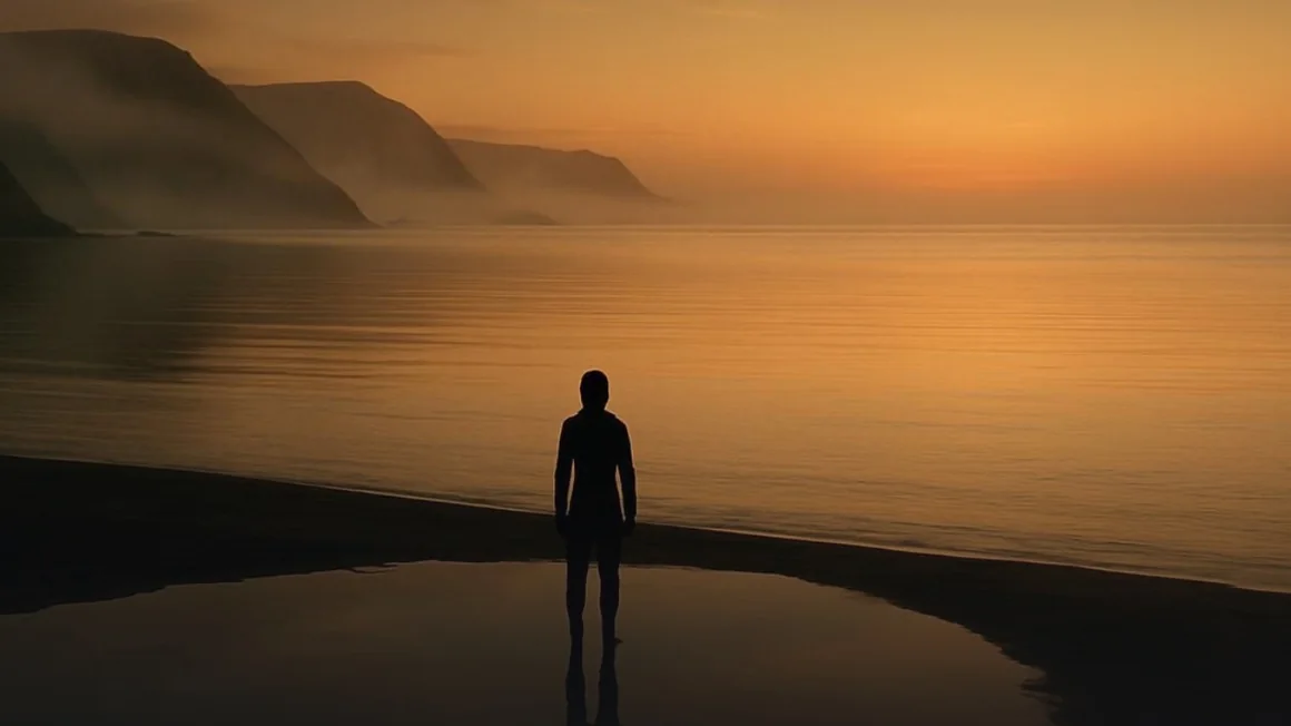 The Sea of Sentara at dusk — a lone figure on the shore of a still gold sea, one of the thirteen places of Meldoria