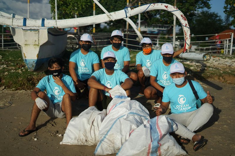 group of grant-funded nonprofit workers sitting doing ocean clean up work