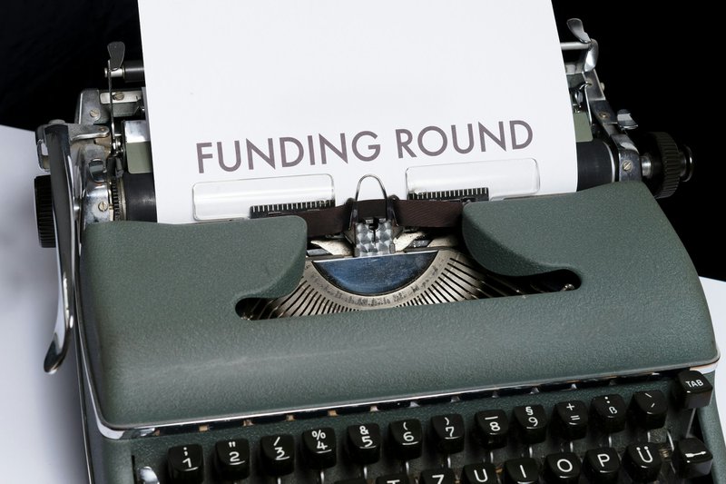a typewriter contrasting with modern ai-powered grant drafting abilities
