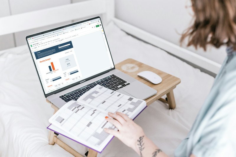 a person sitting on a bed with a laptop learning how to find grants for nonprofits