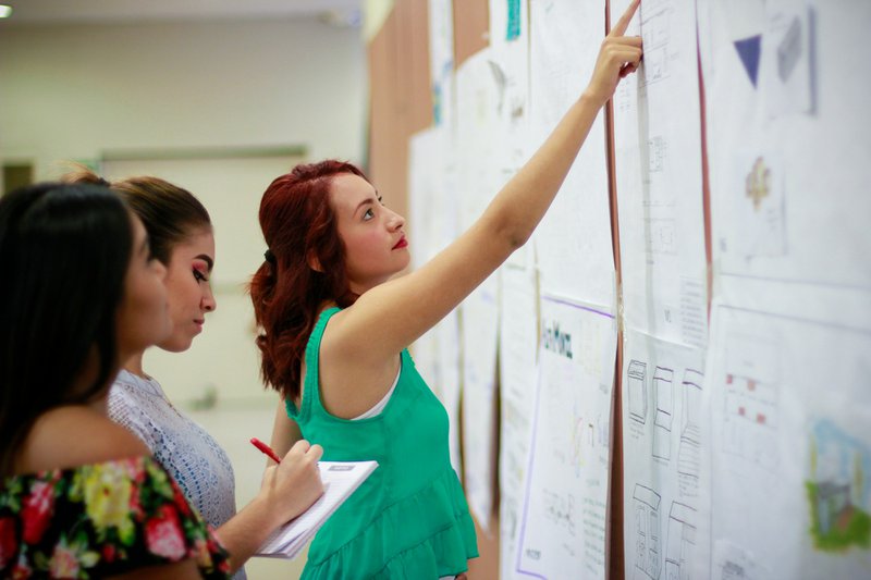 woman pointing at paper to pick a grant opportunity to use ai for grant writing