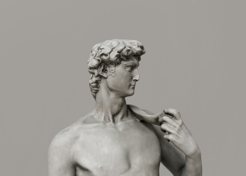 a white marble statue of a man who could be David who took on Goliath, a metaphor for small nonprofit grant writing